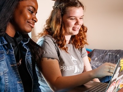 Two students looking at computer